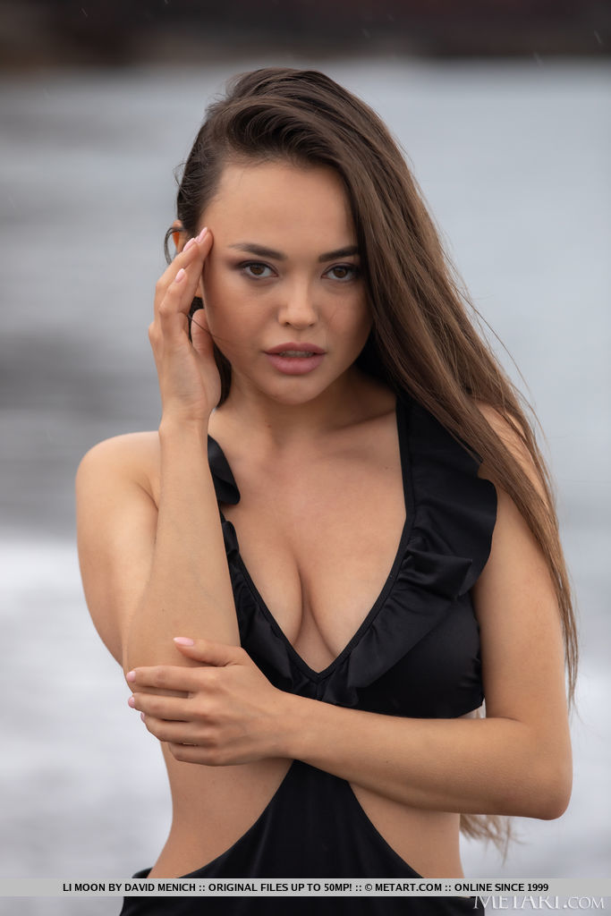 Asian beauty Li Moon is in the mood for skinny dipping, peeling off her outfit at the water’s edge and caressing her gorgeous breasts, nipples stiffening in the ocean breeze.
