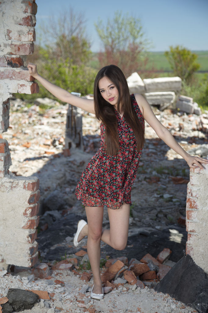 Li Moon undresses amidst the ruins and shows off her juicy, Asian ass