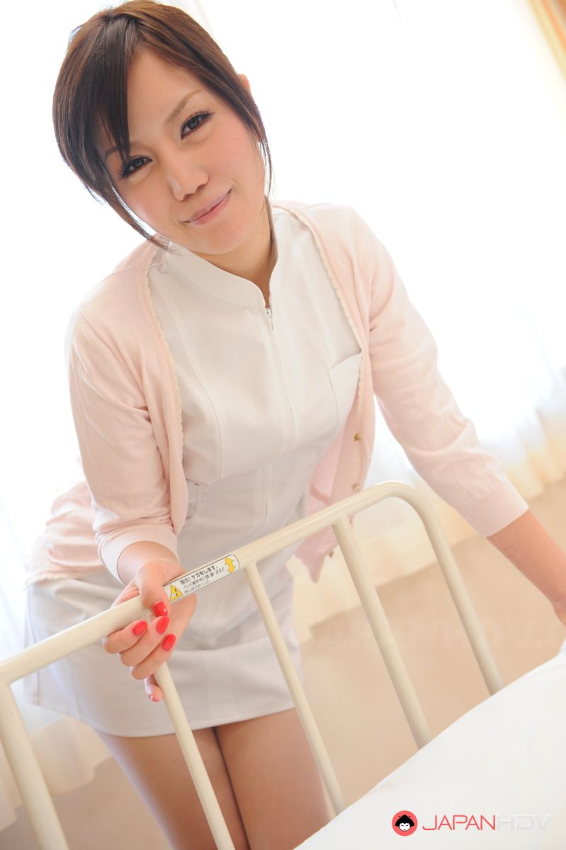 Nurse Yuri Konishi sits with hot ass up in the air on hospital bed.