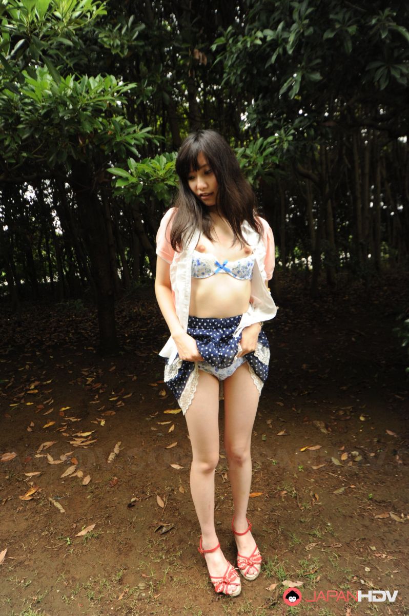 Riko Tabe shows boobs and trimmed pussy under skirt in a park.