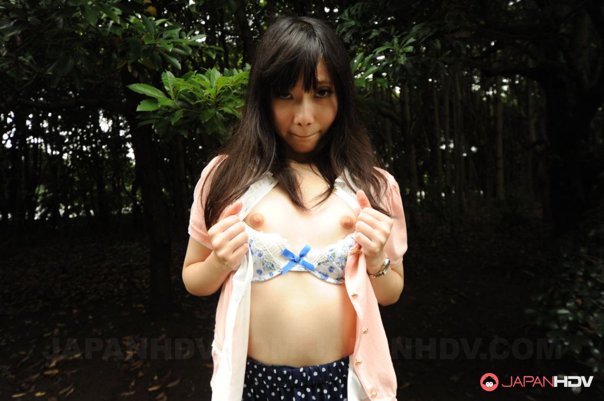 Riko Tabe shows boobs and trimmed pussy under skirt in a park.