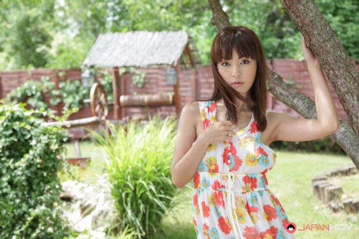 Marica takes off her clothes in a garden